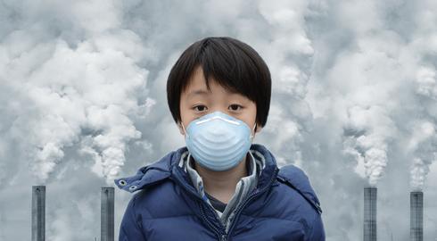 Boy in front of coal power plant